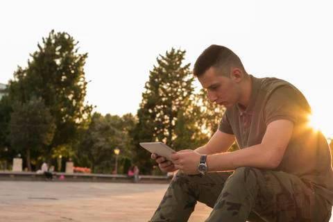 Young man looking at screen of digital tablet Stock Photos