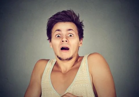 Young man looking shocked scared Stock Photos