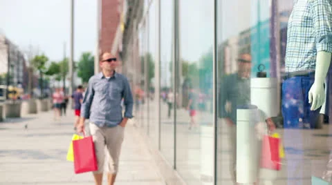 Young man looking at shop window in the city HD Stock Footage 24957184