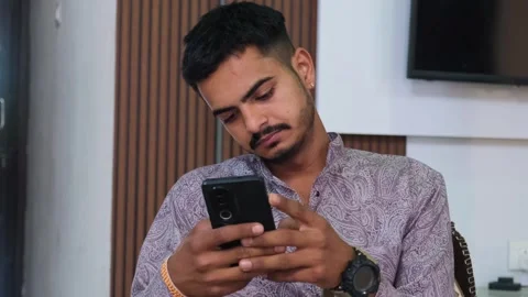 Young Man Looking at Smartphone and Feeling Sad Stock Footage 330738435