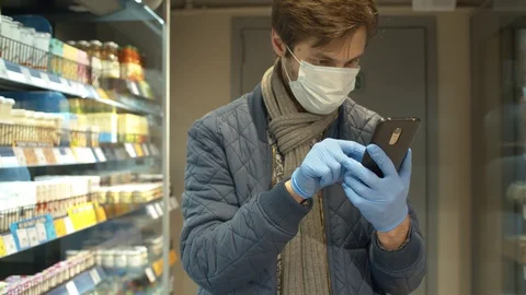 Young man looking in smartphone in the store Stock Footage 128471986