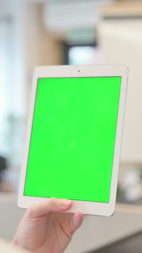 Young Man Looking at Tablet with Green Chroma Screen, Vertical Video Stock Footage 340034222
