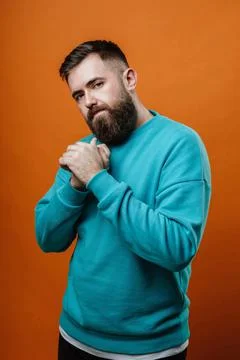 Young man looking thoughtfully at the camera Stock Photos