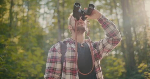 Young Man Looking Through Binocular In Forest Stock Footage 252016727