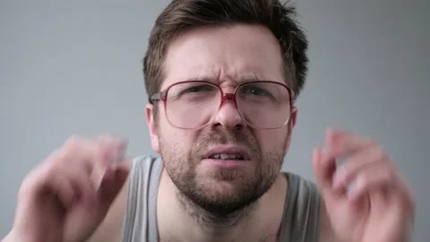 Young man looking through huge glasses in shock with surprise expression. Stock Footage 119936157