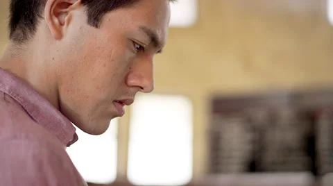 A young man looking at the train schedule and his tablet at a railroad terminal Video stock 57510248