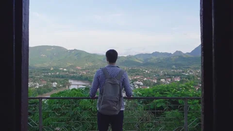 Young Man Looking View Of Luang Prabang City From Phousi Hill Video stock 154453372