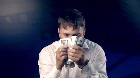 Young man looks back while counting a big amount of money 库存影片 68566139