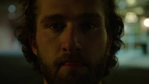 Young Man Looks into Camera Stock Footage 77207448