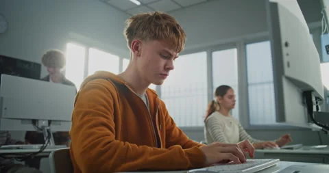 Young Man Looks at Camera While Learning Programming and Design Stock Footage 318519487