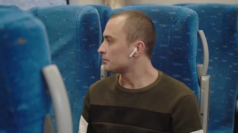 The young man looks out of the train window, then returns to the book. winter Stock Footage 199519859