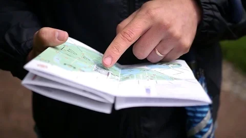 A young man looks at a paper map, checks the route. slow motion, 1920x1080, full Stock Footage 78935884