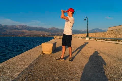 Young man looks in the setting sun Stock Photos
