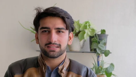 Young man looks sharp and focus as he is lost in deep thought trying to analyze  Stock Footage 101286254
