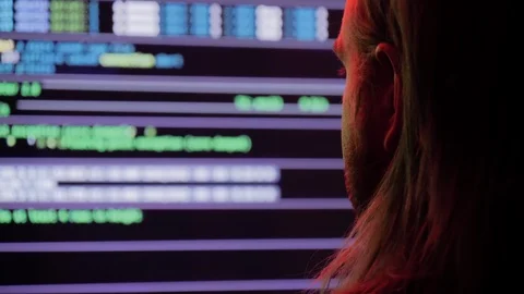 Young man looks upon data stream from computer monitors Stock Footage 118977305