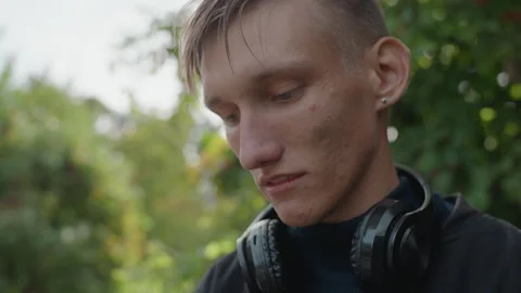 Young man lost in reflection, Serene image of man contemplating outdoors Stock Footage 327664720