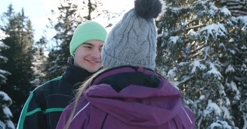 Young man lovingly looking at his partner on a beautiful snowy day Vídeo Stock 85072454
