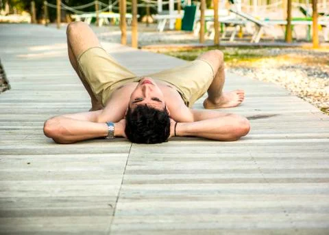 Young Man Lying on Back on Sun Deck Stock Photos