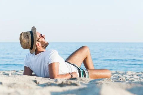 Young man lying on the beach Stock Photos