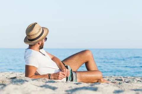 Young man lying on the beach Stock Photos