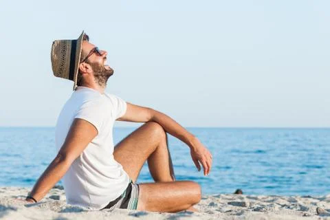Young man lying on the beach Stock Photos