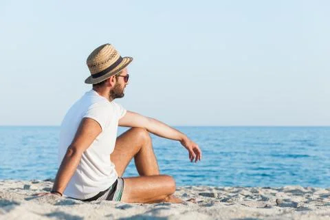 Young man lying on the beach 스톡 사진