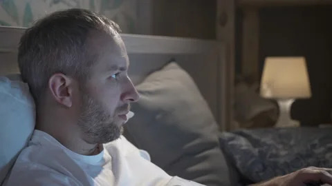 Young man lying in the bed with laptop before sleeping. Stock Footage 161819030