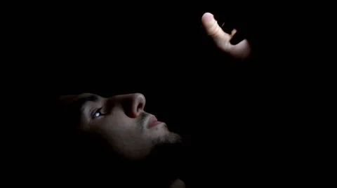 Young man lying on the bed using smartphone at night Stock Footage 63998382