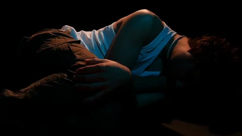 Young man lying in fetal position. studio shooting on black background 스톡 동영상 126858612