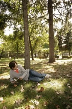 Young man lying on field Stock Photos
