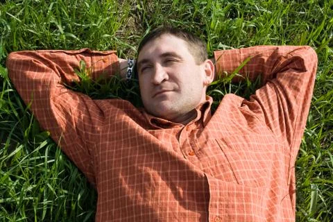 Young man lying on the grass Stock Photos
