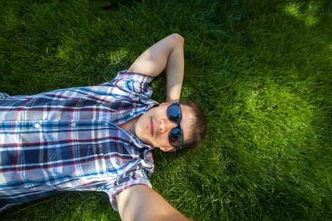 Young man lying on the grass Stock Photos