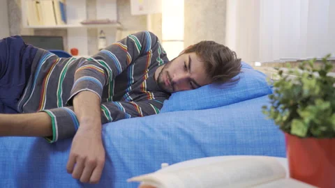 The young man lying in his bed is thoughtful. Stock Footage 222524521