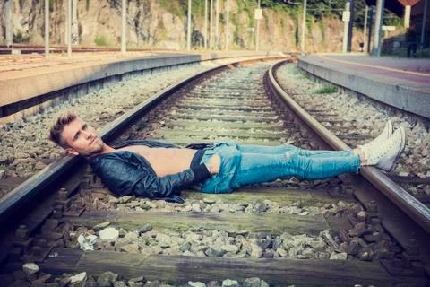 Young man lying on rails Stock Photos