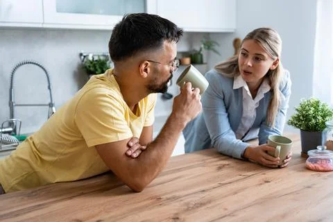Young man made first coffee for his girlfriend in formal wear who goes to w.. Stock Photos