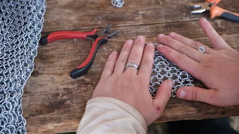 Young man make medieval chain armor with modern tools Stock Footage 113187129