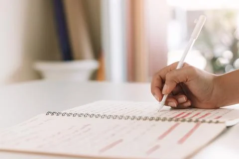 Young man make notes sit at work desk while study online watching webinar pod Stock Photos