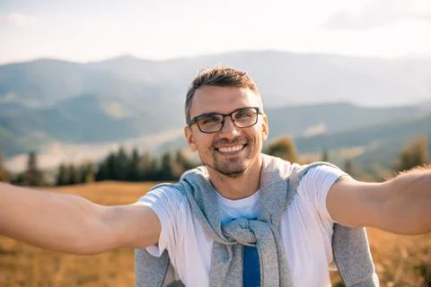 Young man make selfie on camera mountain landscape Stock Photos