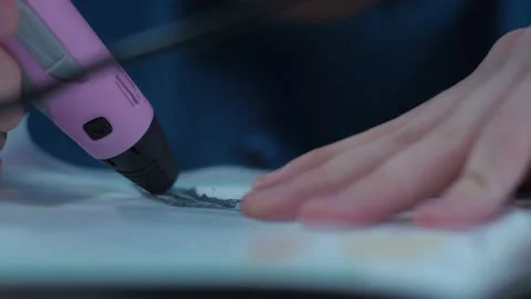 A young man makes a 3 d model with a pen. the model is made of plastic Stock Footage 146735772