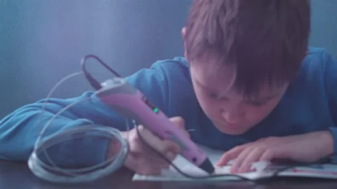 A young man makes a 3 d model with a pen. model in the haze of light Stock Footage 146857649