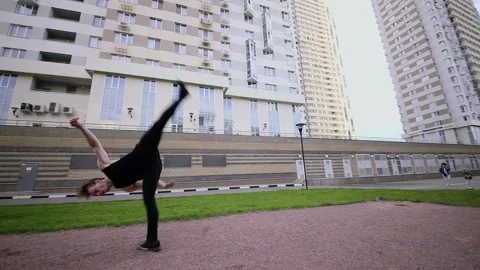 Young man makes acrobatic performance on sports playground. Slow motion Stock Footage 276377676