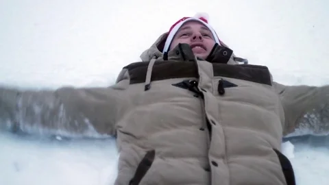 The young man makes an angel in the snow Video stock 70678803