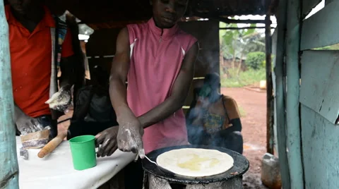 A young man makes chapattis in the Jinja, Uganda. Stock Footage 59795346