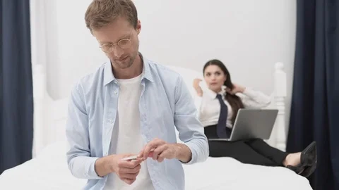 A Young Man Makes A Manicure While His Wife Is Working Stock Footage 126127519