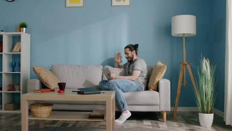 Young Man Makes Online Call to Friends Vídeo Stock 129891393