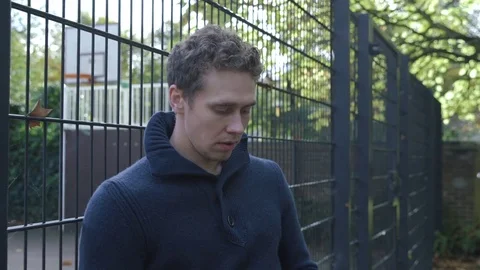 Young man makes a phone call and becomes really agitated Vídeo Stock 72681253