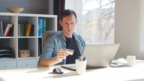 Young man makes purchases on the Internet using a bank credit card. The person Stock Footage 172469172