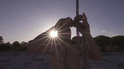 Young Man Makes Rope Knot on Wood Post on the Beach, Slow Motion Stock Footage 81492467