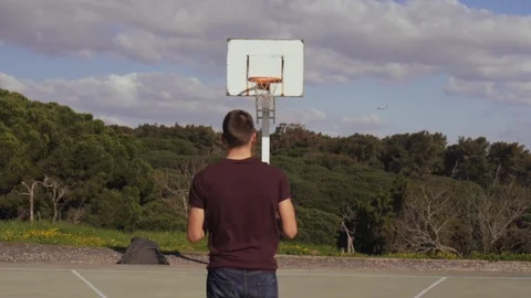 Young man makes a shot for the hoop. Video stock 126653285
