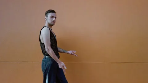 Young man in makeup practices hands performance and catwalk Stock Footage 192079533
